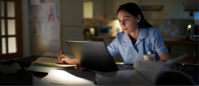Caregiver alert and working at a desk during the overnight shift