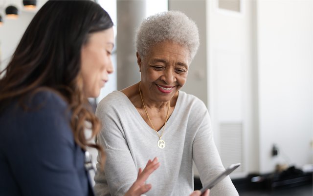 Family member reviewing paperwork with a caregiver